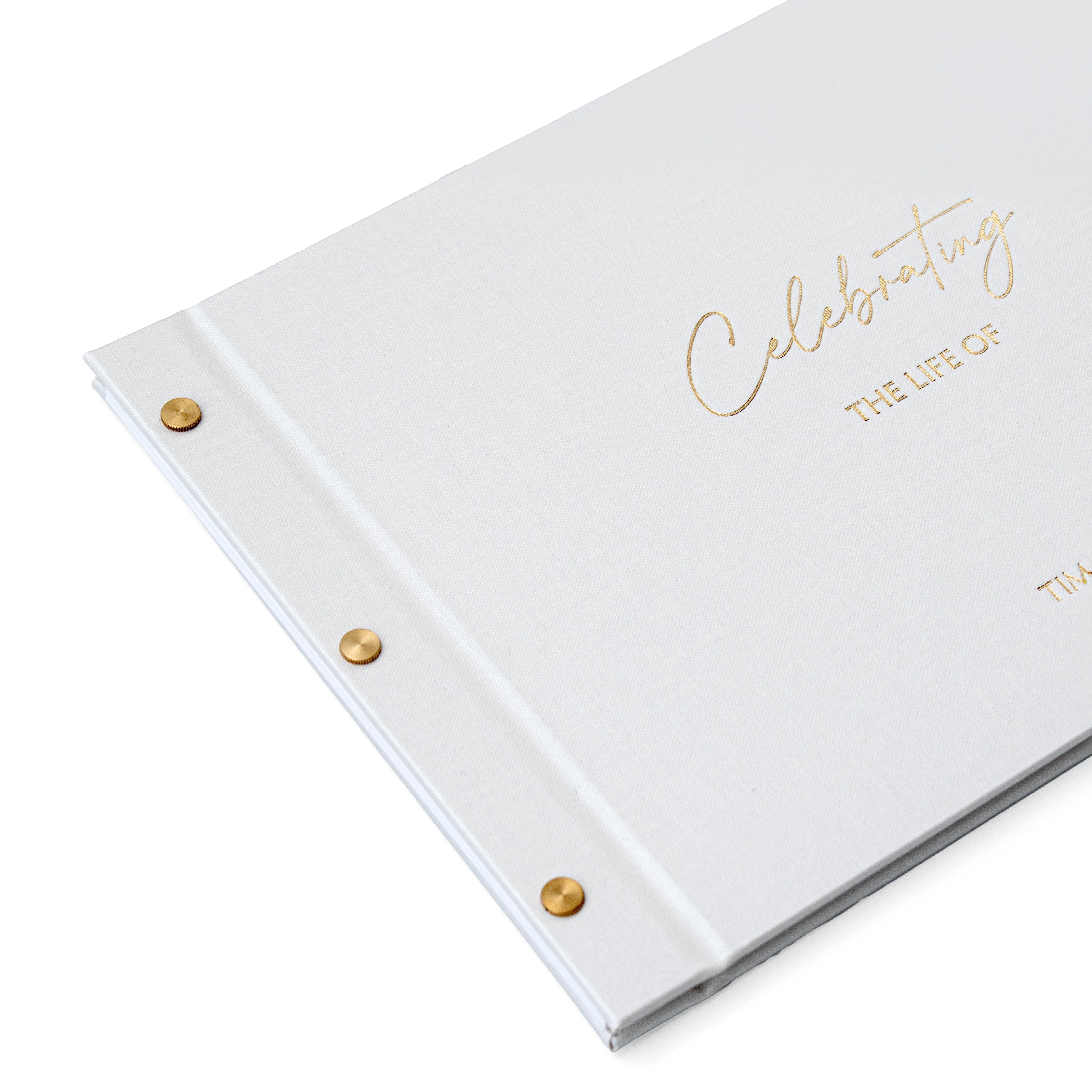 White condolence book with gold foil Celebrating the life of on the cover