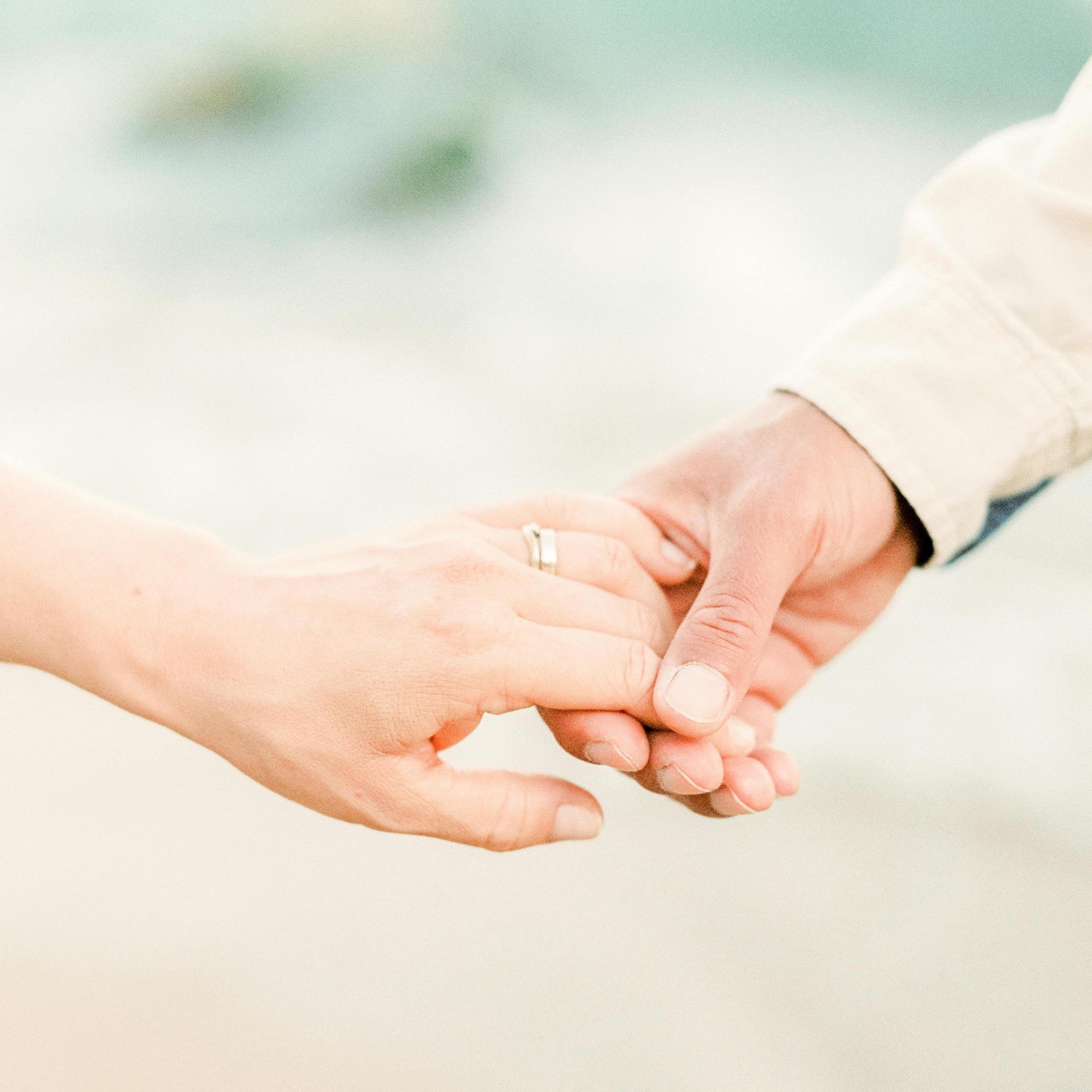 engaged couple holding hands