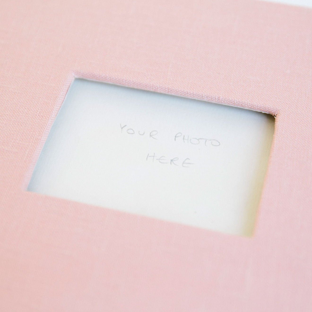 close up of guestbook with phto insert in cover of pink linen bound book