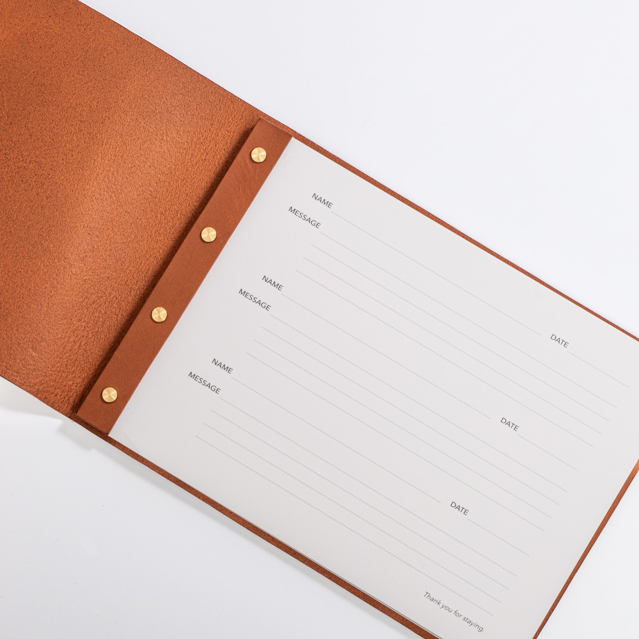 Open leather visitors book showing structured message pages