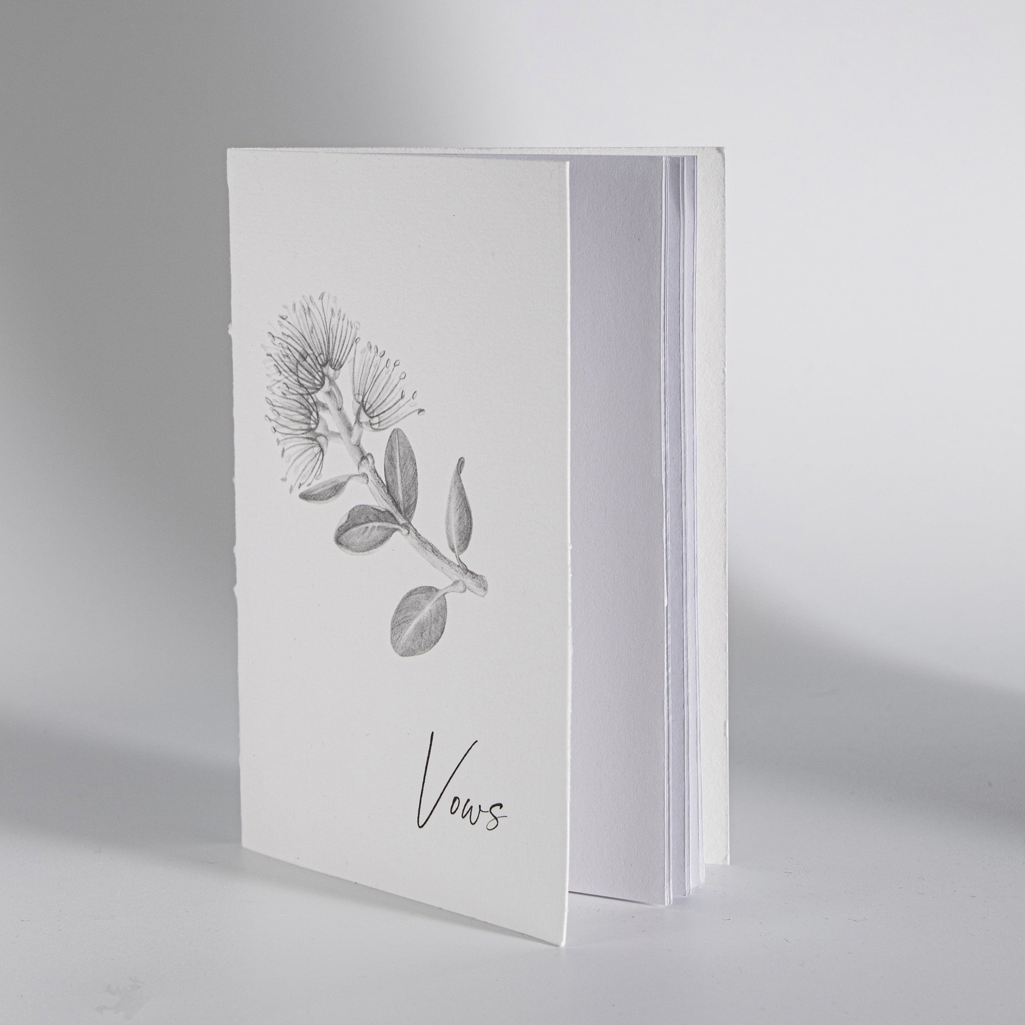 Minimal Pohutukawa wedding vow book photographed for modern wedding keepsake set