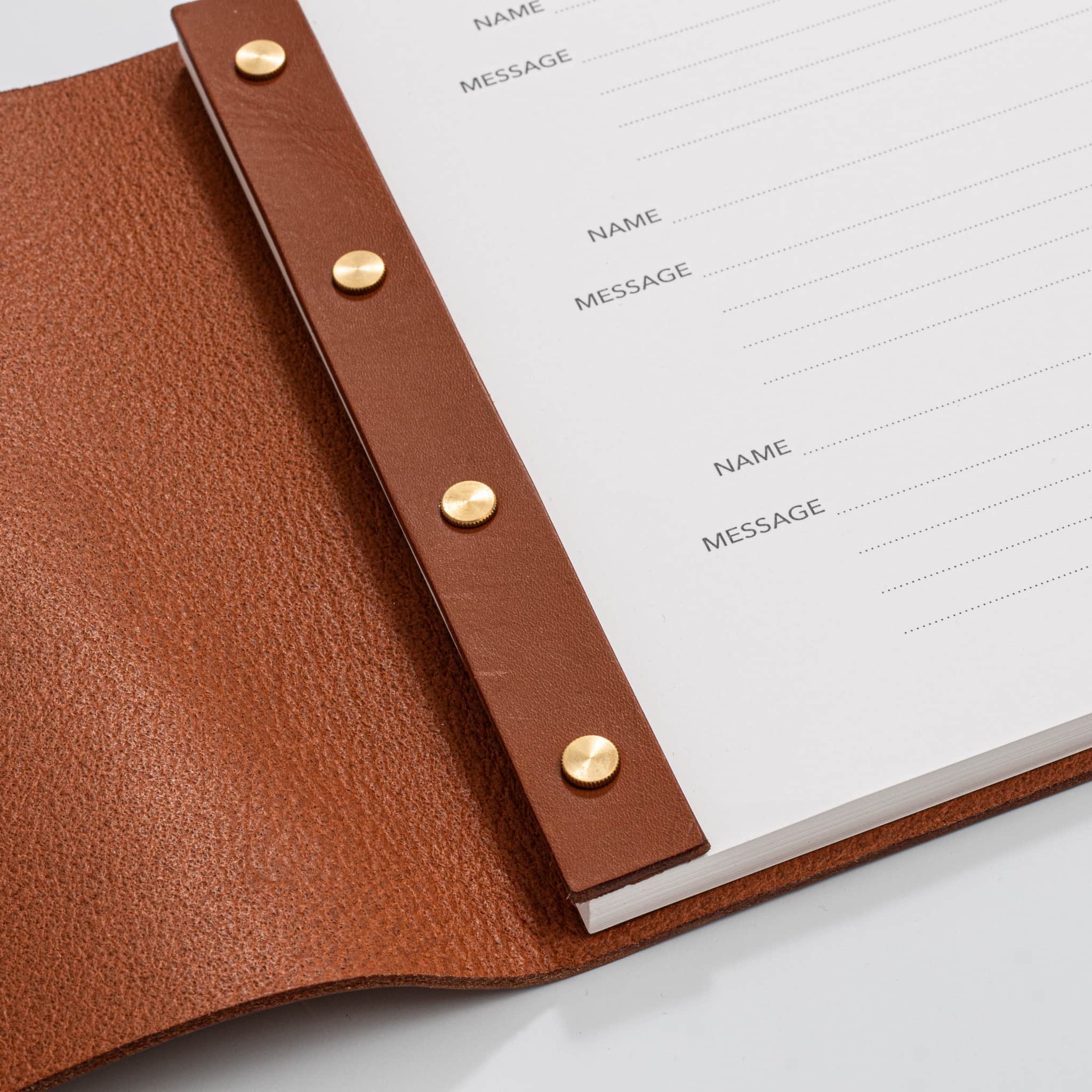 Post bound leather visitors book with brass fixings detail