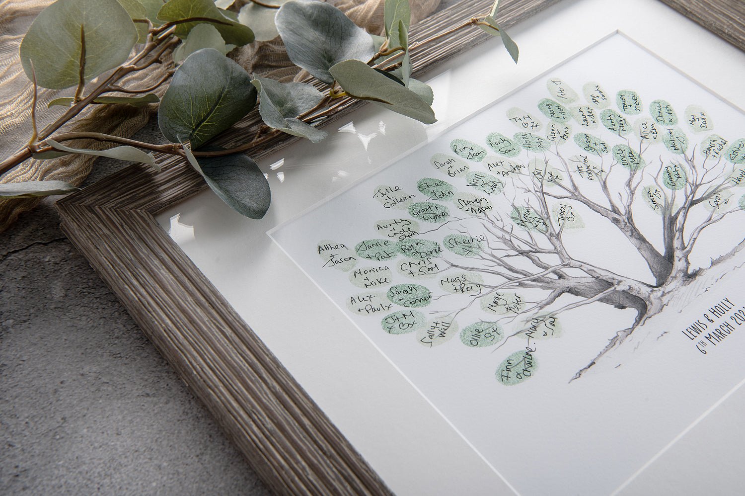 framed fingerprint tree guestbook with greenery 