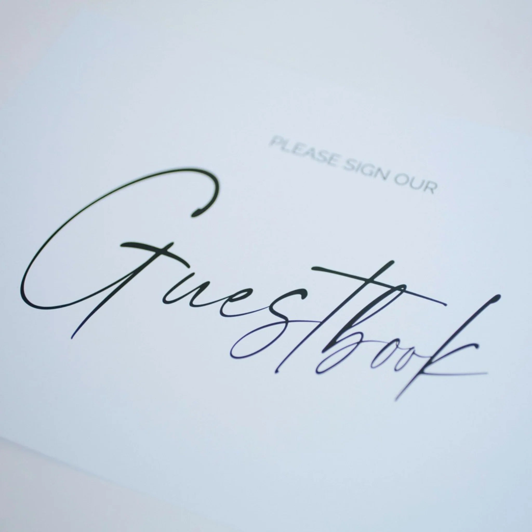 Guestbook cover with 'Please sign our Guestbook' text on a light blue background