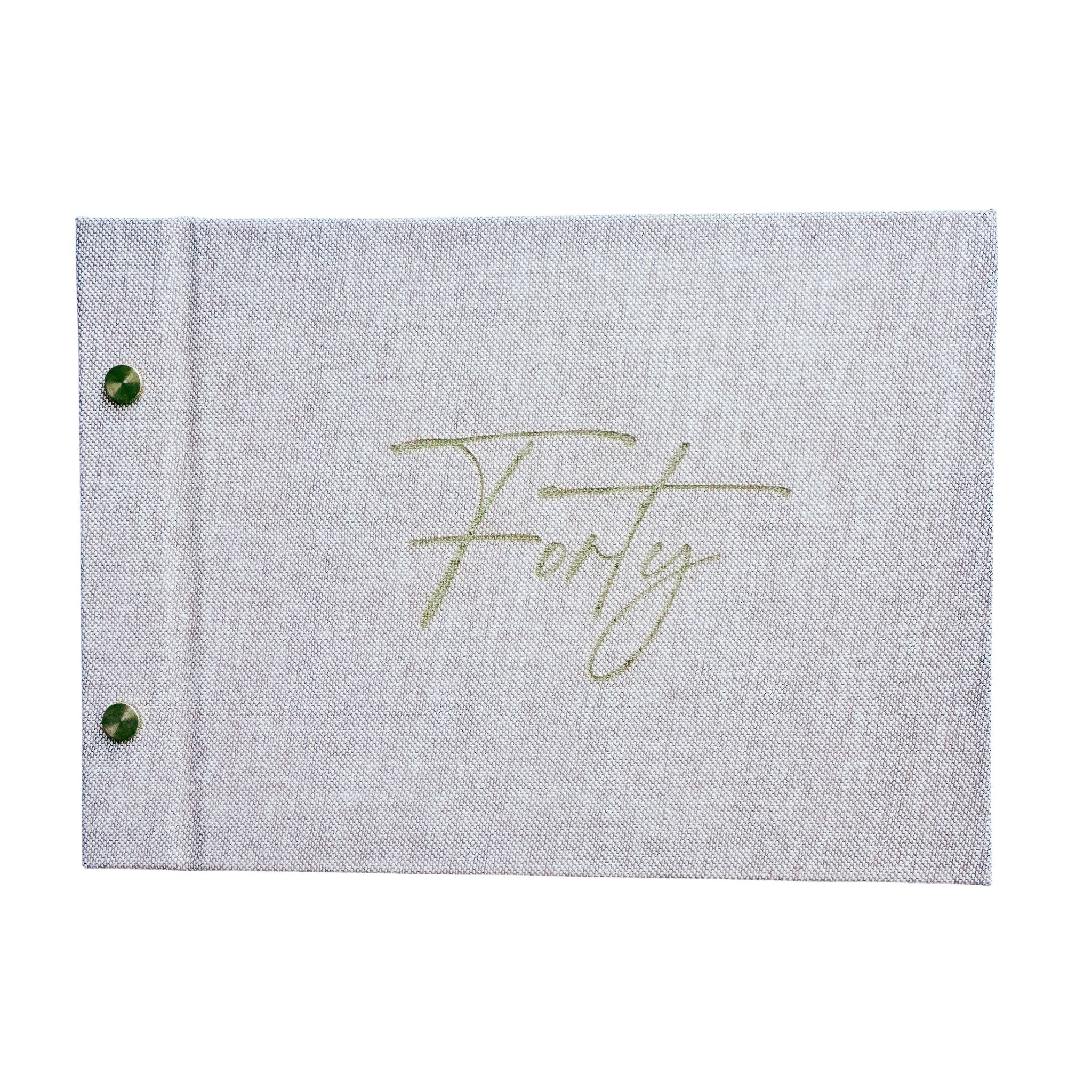 Oatmeal linen birthday guestbook with 'Forty' engraved on a white background