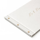 White guestbook album with 'Mr & Mrs' text in gold foil on a white background