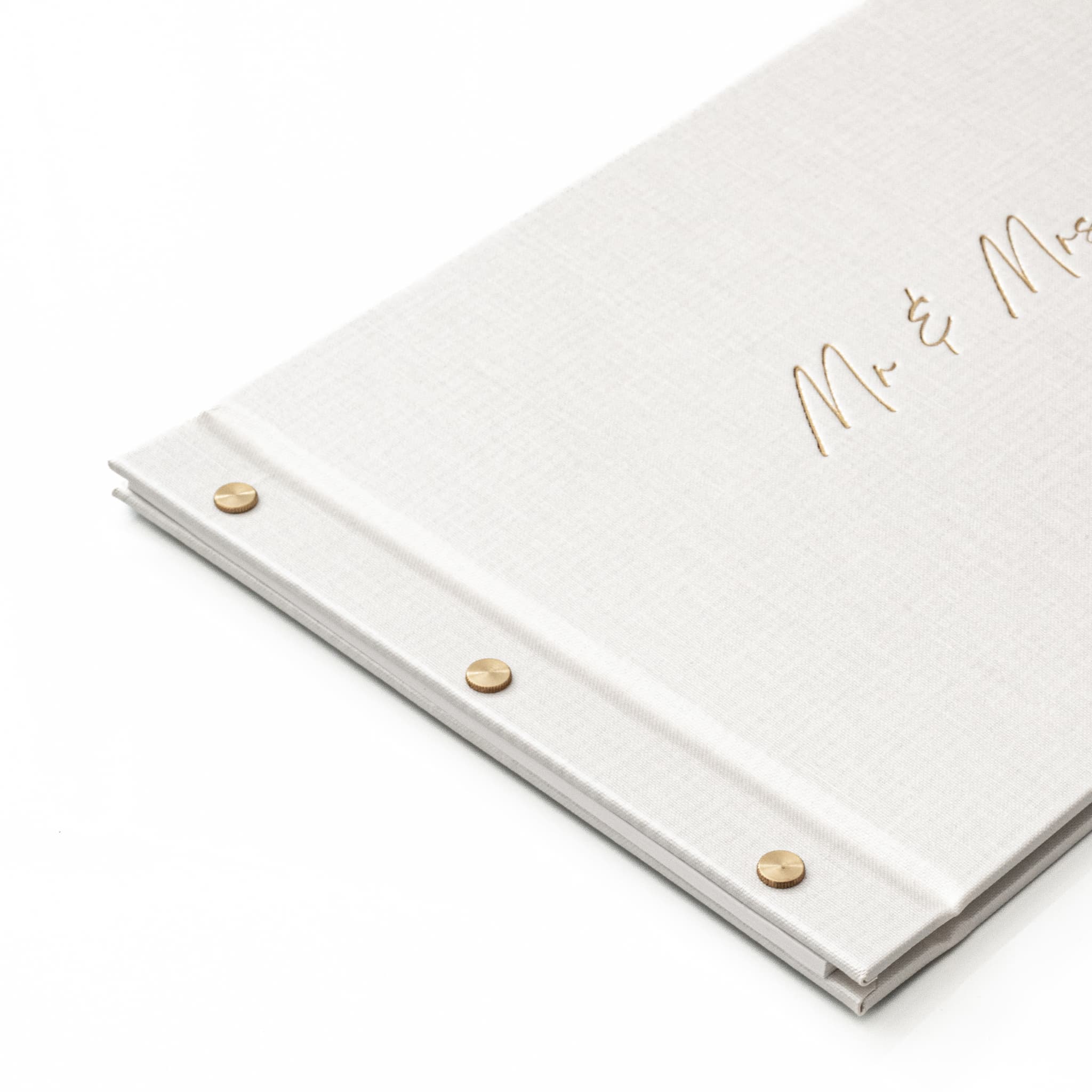 White guestbook album with 'Mr & Mrs' text in gold foil on a white background