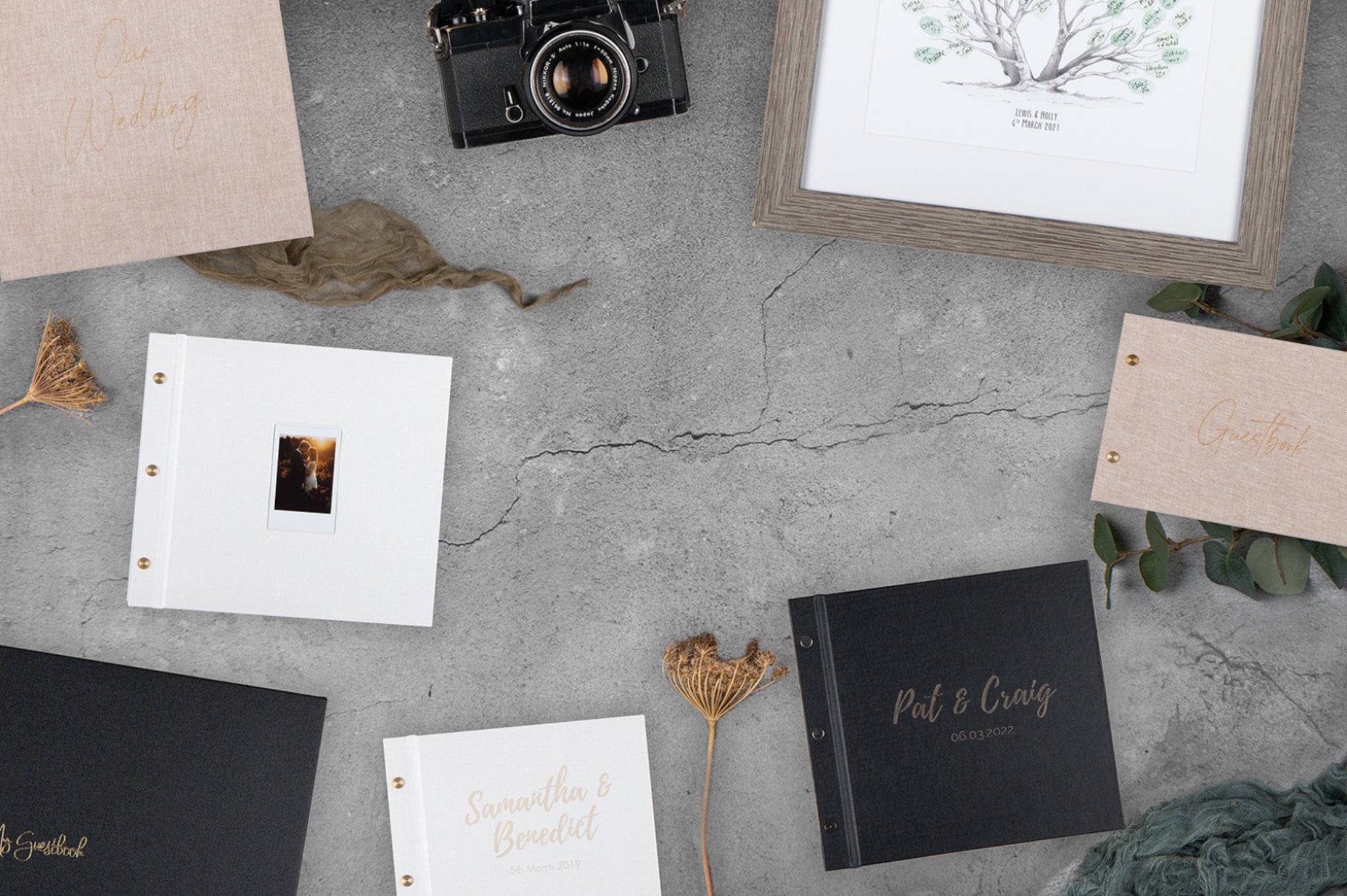 Flat lay of handcrafted wedding guestbooks in linen and foil debossed designs, personalised and Instax photo styles by My Guestbook New Zealand.