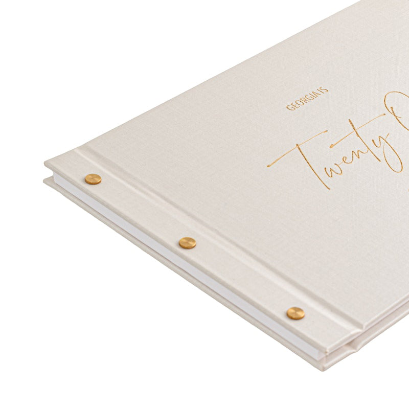 white personalised-21st-birthday-guestbook with gold text on cover