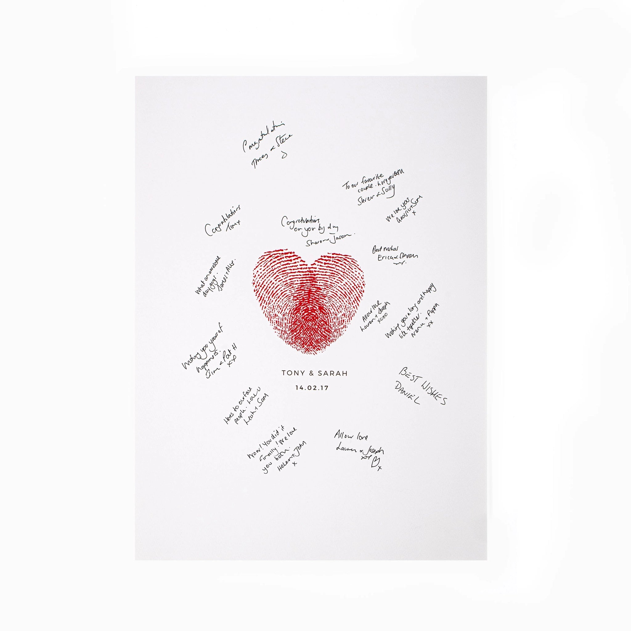 Personalised fingerprint heart wedding guestbook surrounded by handwritten messages from wedding guests
