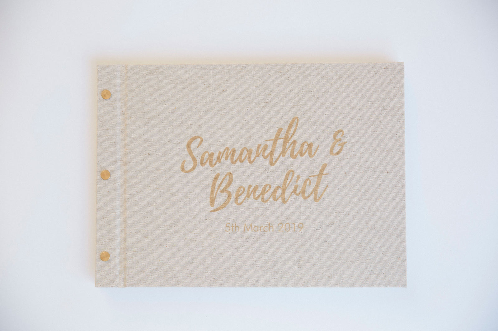 A beautifully crafted, personalised artisan wedding guestbook featuring custom cover text, resting on a clean background.