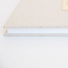 Side view of oatmeal linen guestbook with gold Chicago screw binding