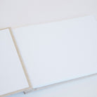 Open A4 guestbook showing Mohawk Superfine pages with gold screw binding