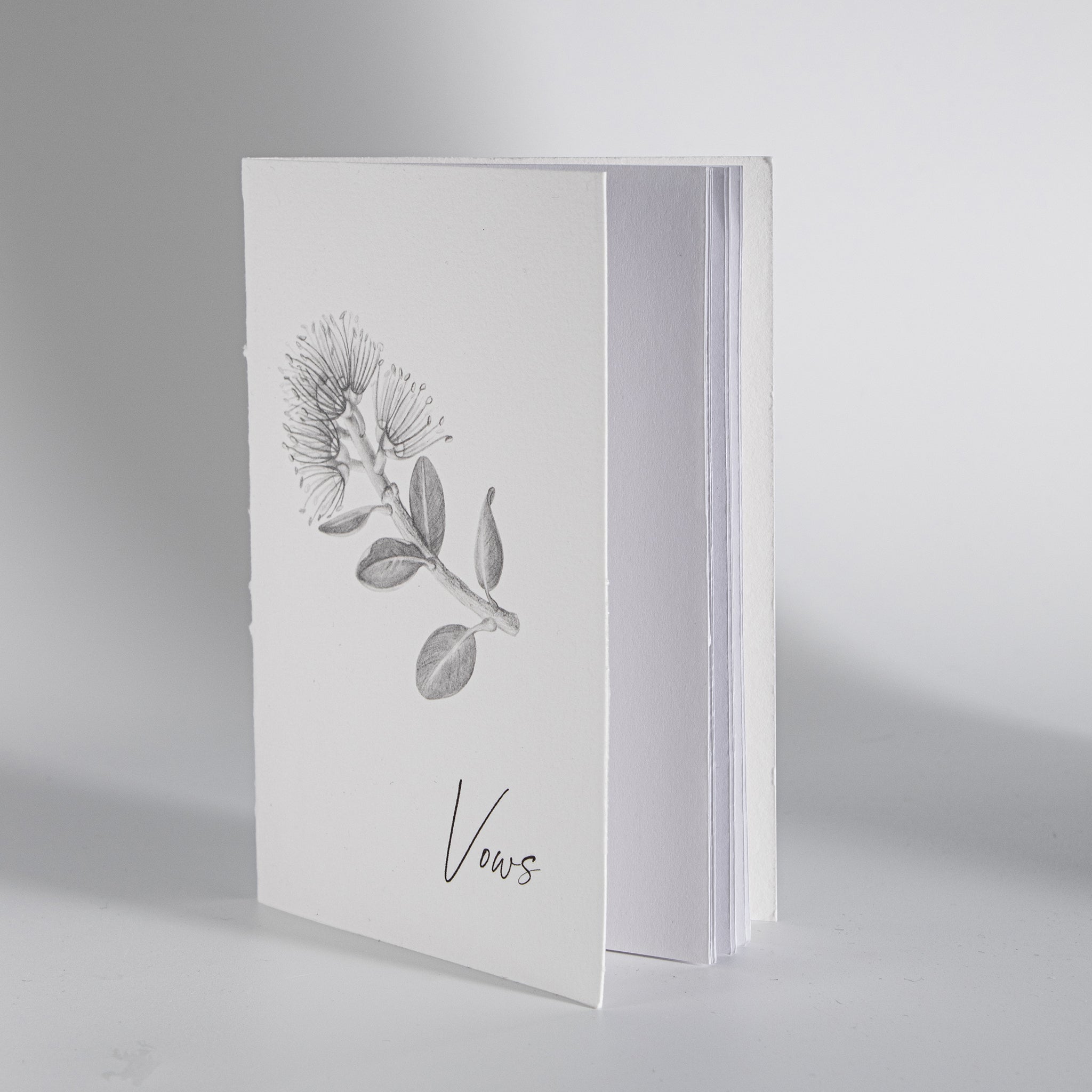 Minimal Pohutukawa wedding vow book photographed for modern wedding keepsake set