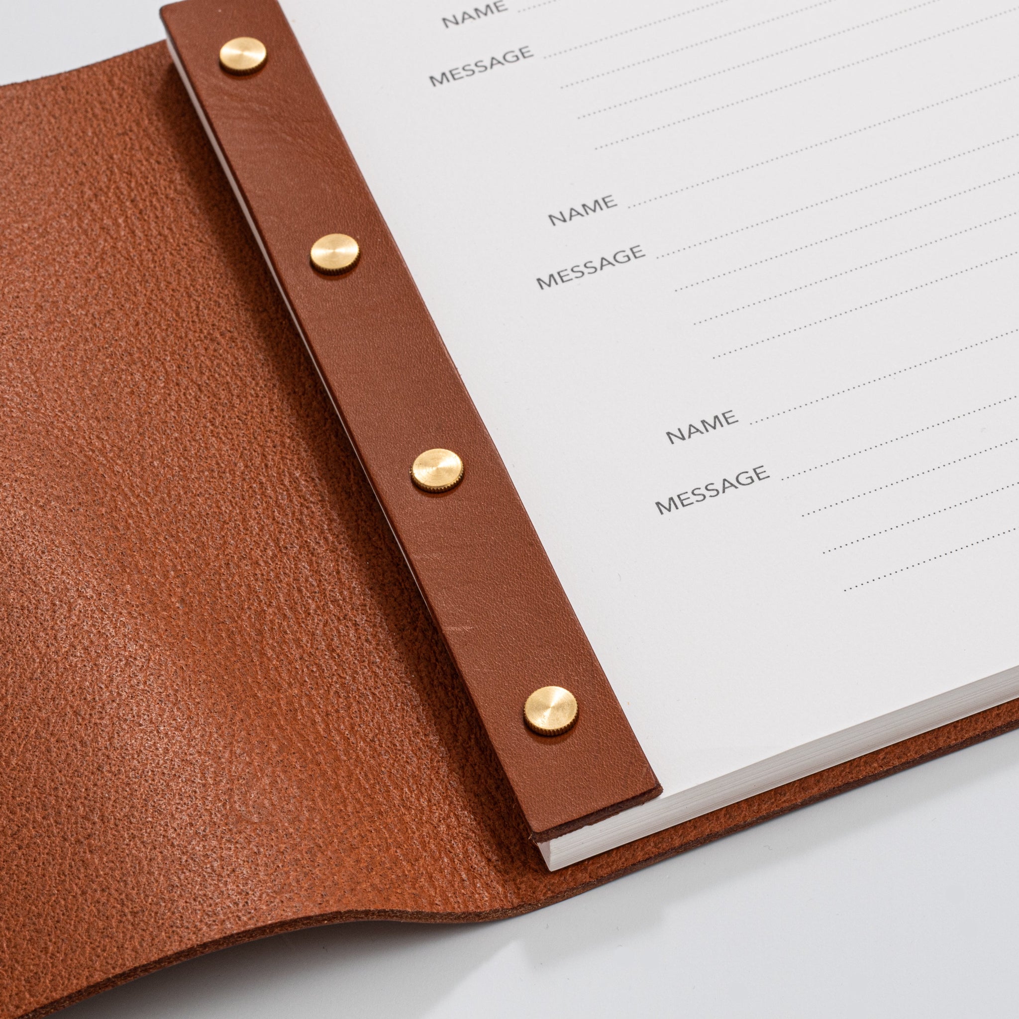 Post bound leather visitors book with brass fixings detail