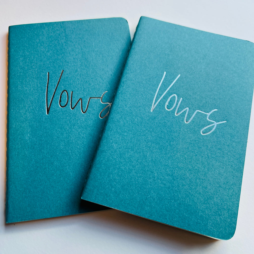 turquoise vow books with silver foil writing on cover