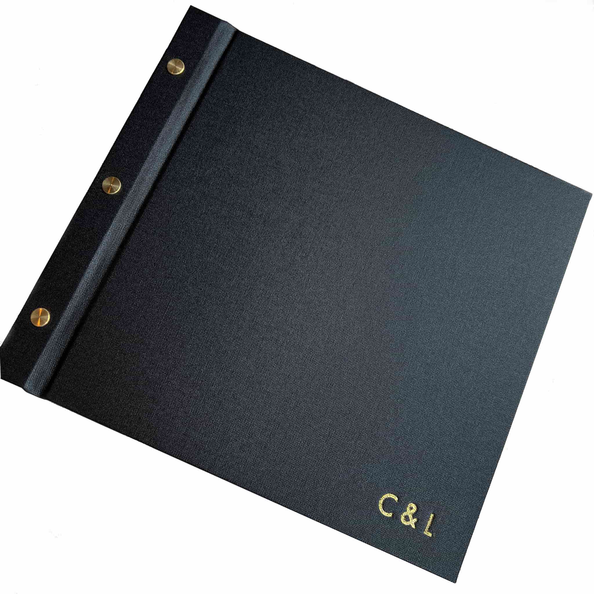 Black instax photo guestbook with gold foil monogram on a white background